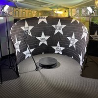 360 photo booth set up inside a star wall backdrop at a Minneapolis venue