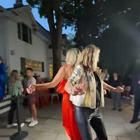 Guests dancing on a 360 photo booth at an outdoor party
