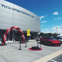 360 photo booth on a red carpet ring with stanchions at a Ferrari dealership