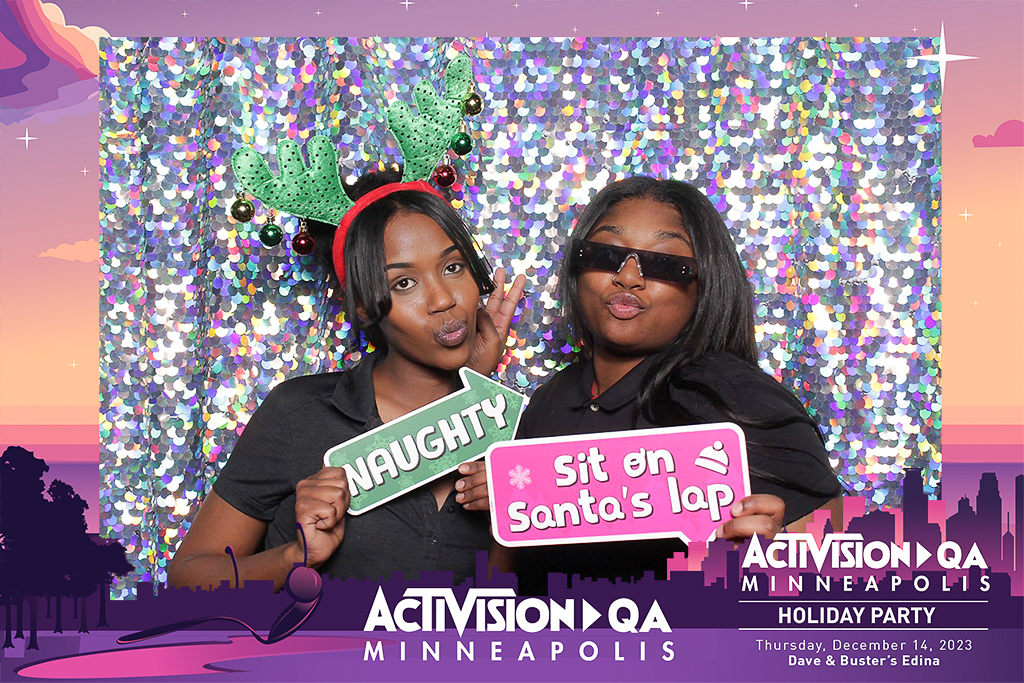 Activision Minneapolis holiday party print of two coworkers with antlers and Naughty sign props