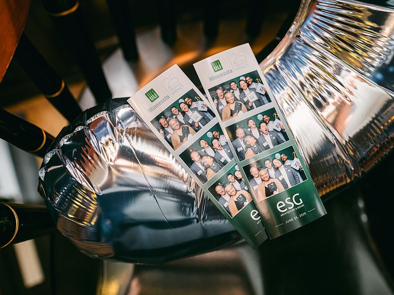 Branded photo strips with a company logo at a corporate event activation
