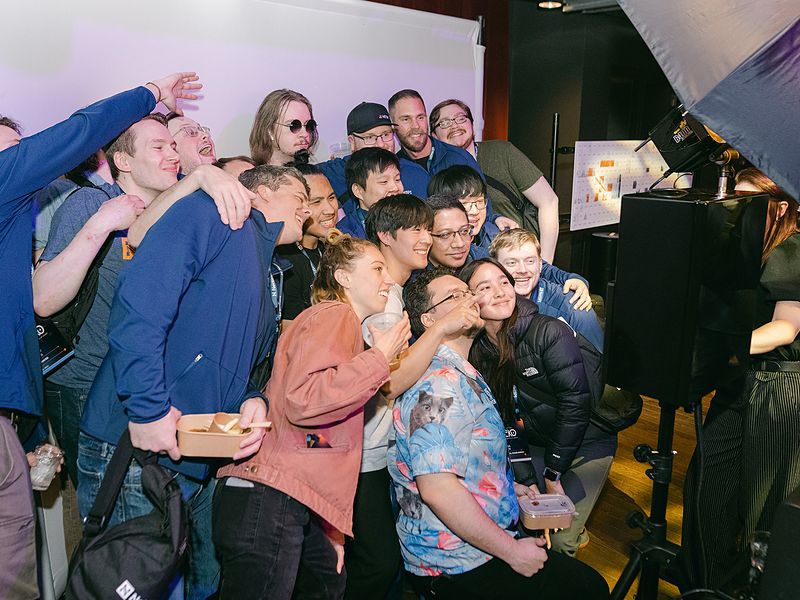 Coworkers crowding into a group photo at a corporate photo booth activation