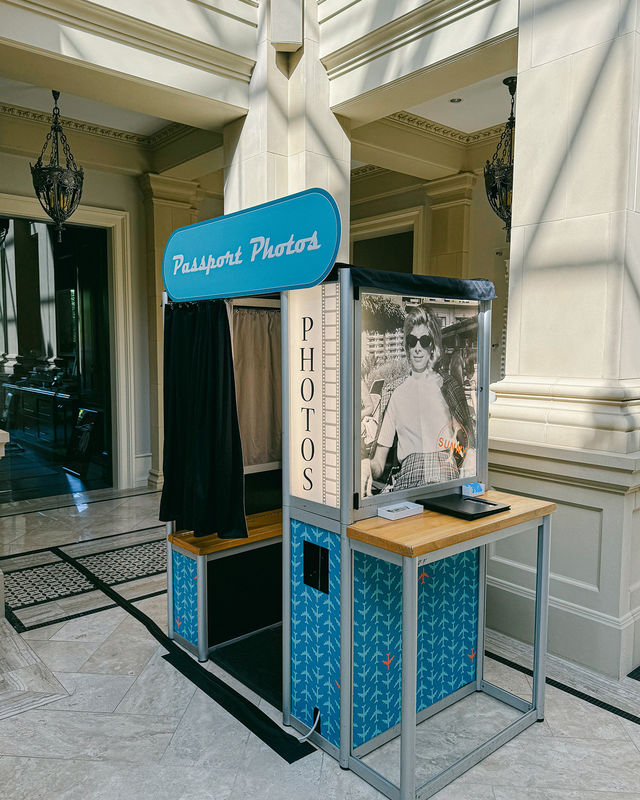 Enclosed photo booth with a full custom blue wrap