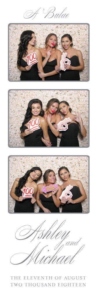 Elegant wedding photo strip of bridesmaids posing with 100 emoji props in front of a flower wall