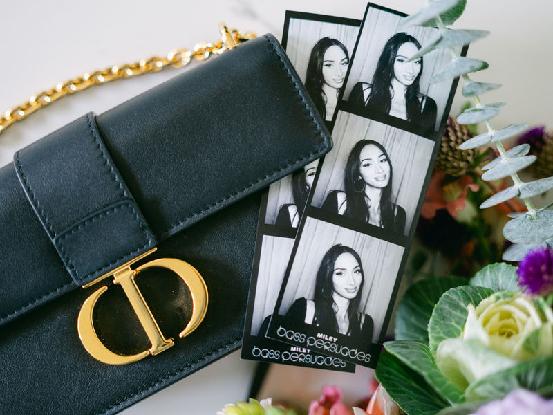 Black and white photo strips from an enclosed photo booth at a fashion brand event