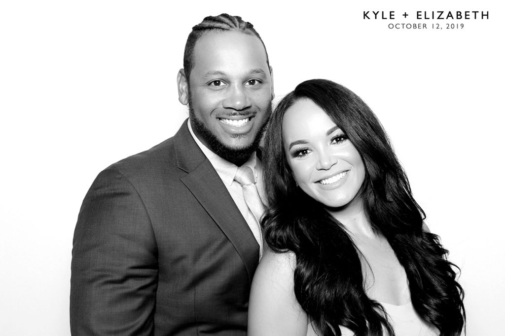 Black and white glam booth portrait of a smiling bride and groom at their Minnesota wedding