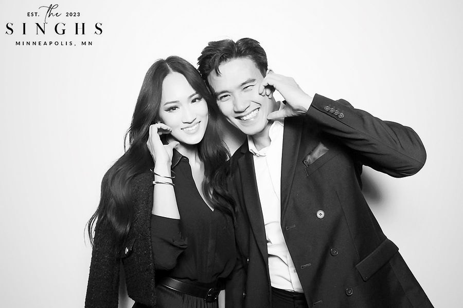 Couple making a heart pose in a black and white glam booth portrait in Minneapolis