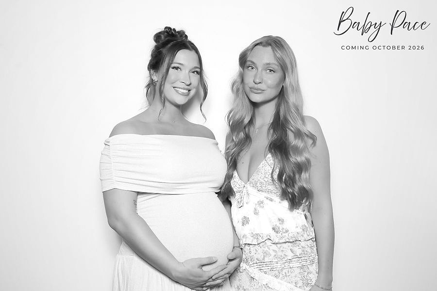 Expecting mom and friend in a glam photo booth portrait at a baby shower