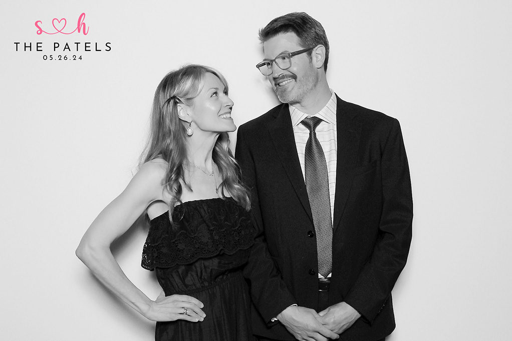Older couple smiling at each other in a glam photo booth portrait at a family wedding