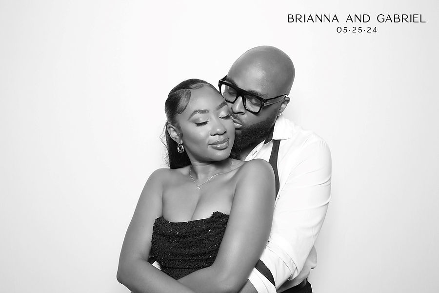 Black and white glam photo booth portrait of a wedding couple embracing at a Minneapolis reception
