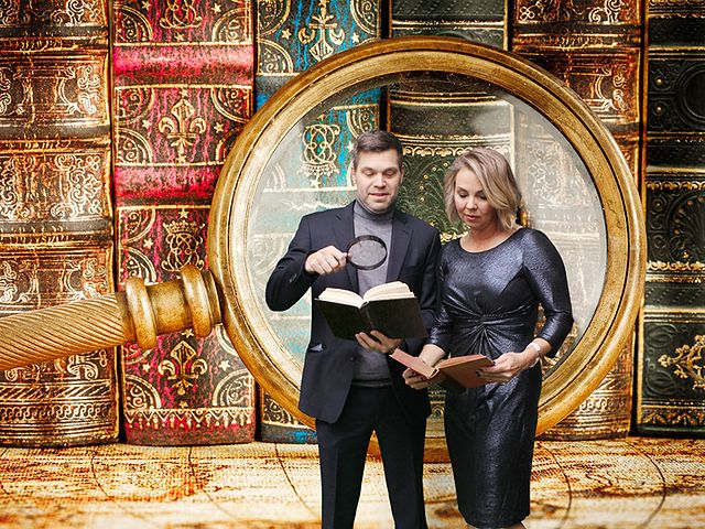 Couple reading old books inside a giant magnifying glass, green screen photo booth print
