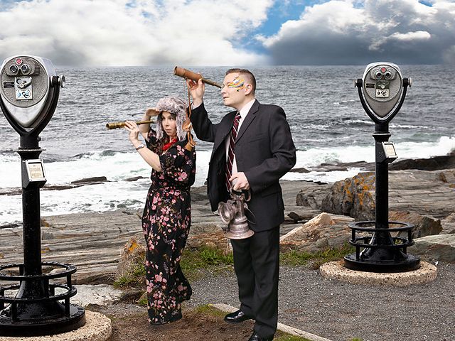 Couple with spyglasses at a rocky ocean lookout, green screen photo booth scene