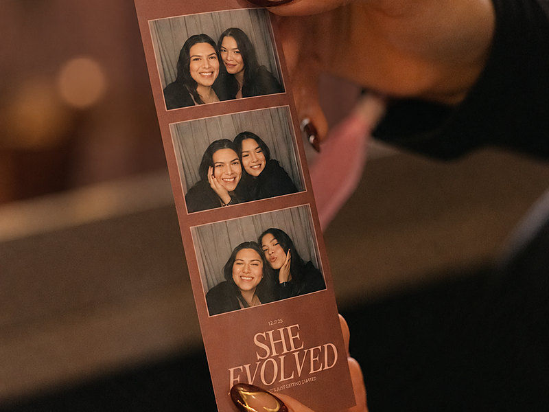 Guest holding a custom color photo strip printed by a traditional photo booth