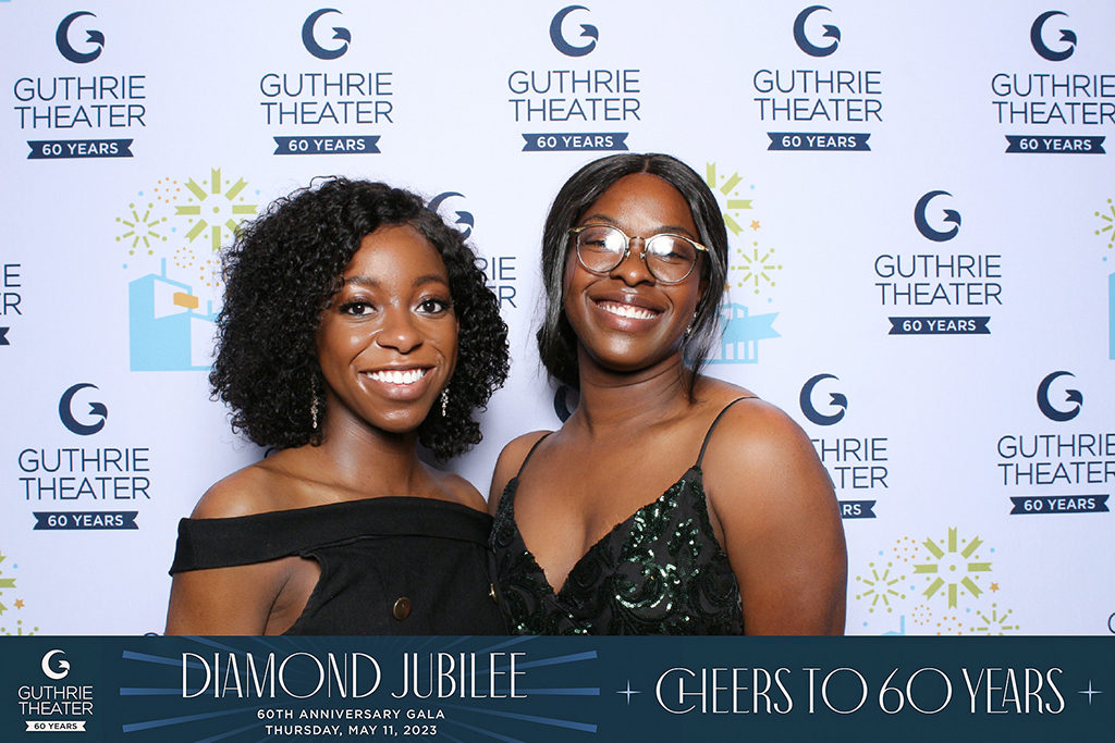 Guthrie Theater 60th anniversary gala print of two women in front of a step and repeat banner