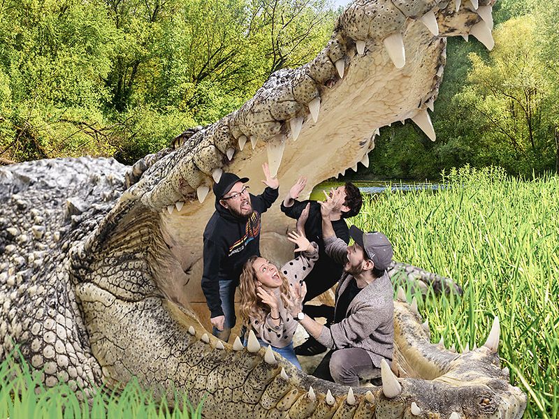 Four friends inside the open jaws of a giant crocodile, immersive green screen photo