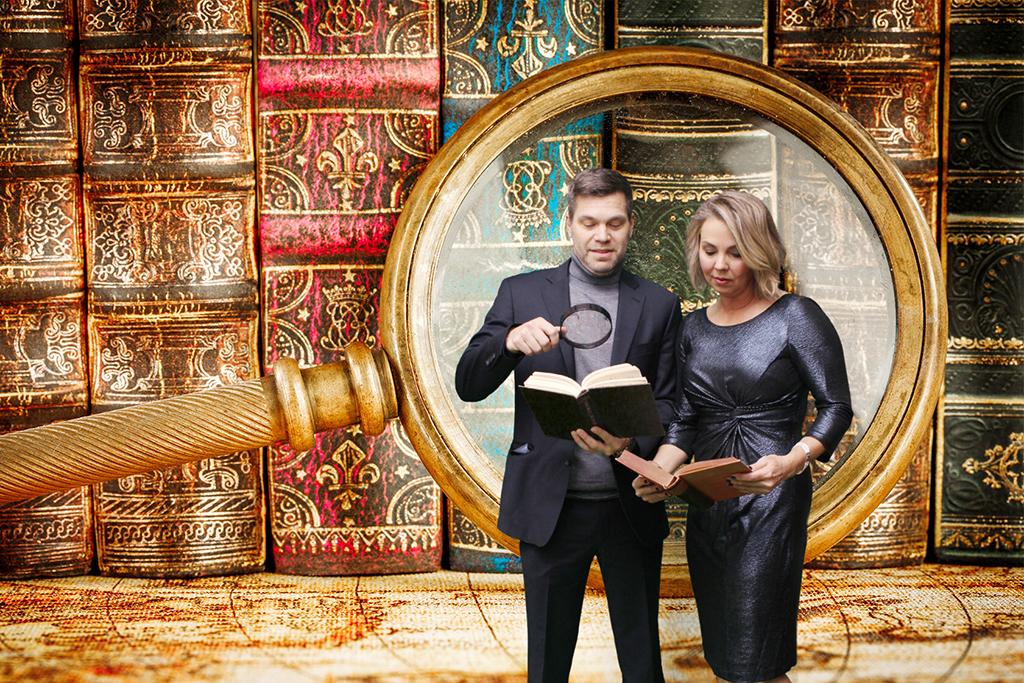Couple reading old books inside a giant magnifying glass, immersive green screen photo