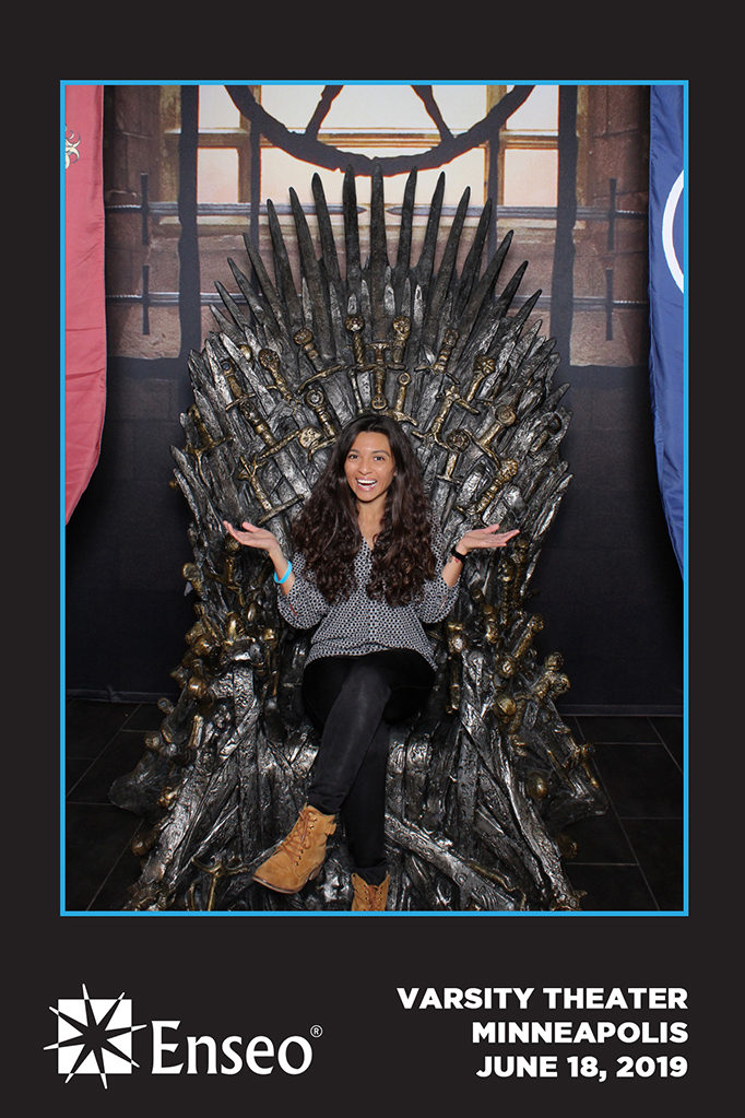 Corporate event print of a guest sitting on an Iron Throne replica at the Varsity Theater Minneapolis