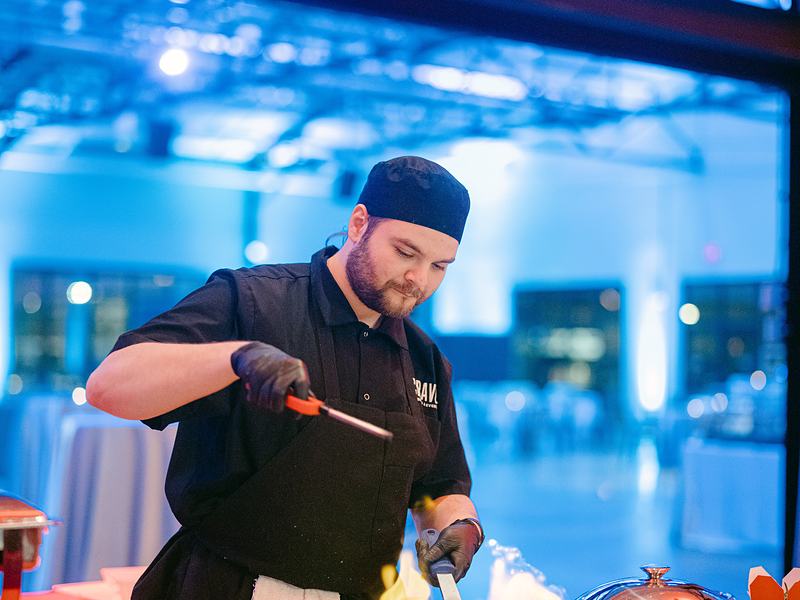 Chef flambeing at a live food station during a corporate event