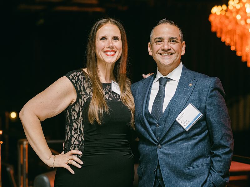 Smiling couple posing together at a formal awards gala