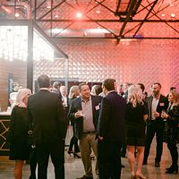 Guests filling a warehouse venue during a corporate party