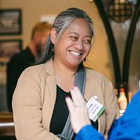 Guest laughing mid conversation at a reception