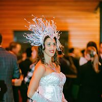Performer in a crystal costume serving drinks at a party