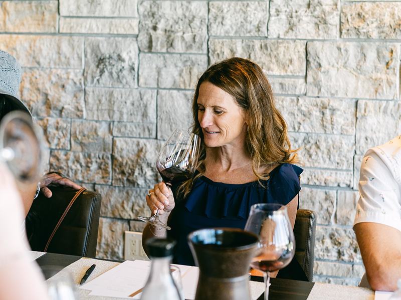 Guest smiling during a wine tasting at a winery event