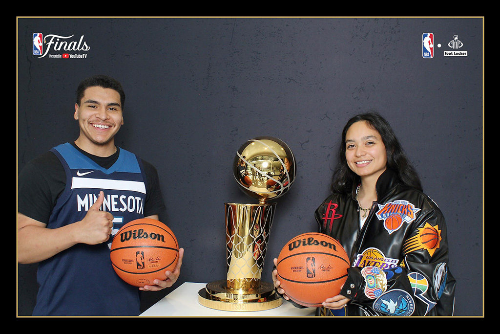 NBA Finals fan event print of two fans holding basketballs beside the championship trophy