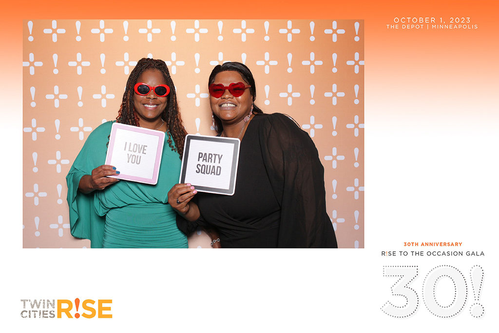 4x6 large print from a 30th anniversary nonprofit gala at The Depot Minneapolis, two women with sign props