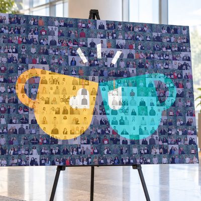 Finished photo mosaic of two coffee mugs made from guest photos, displayed on an easel stand