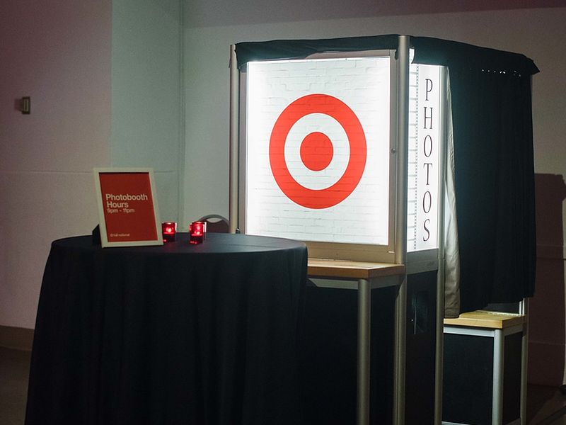 Enclosed photo booth with a retail brand logo lightbox panel