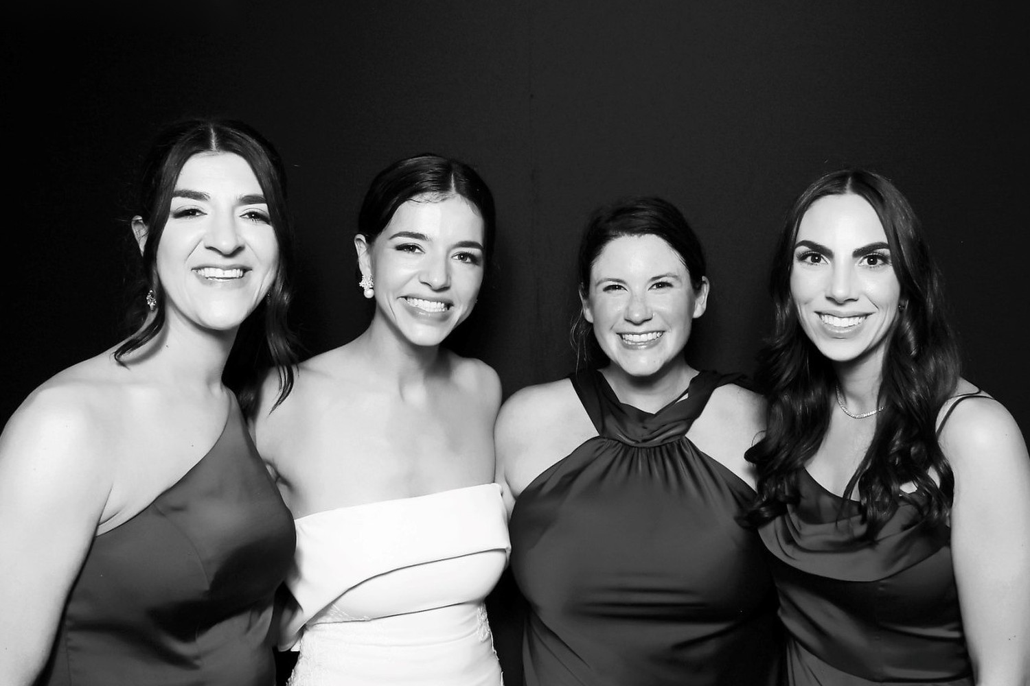 Bridesmaids in a black backdrop glam photo booth portrait