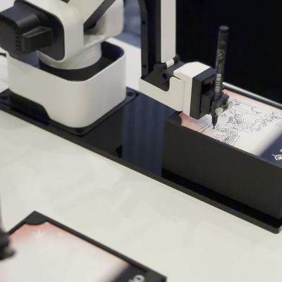 Sketch Bot robot arms drawing guest portraits on branded cards