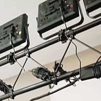 Event lights on a truss above a slow motion video booth
