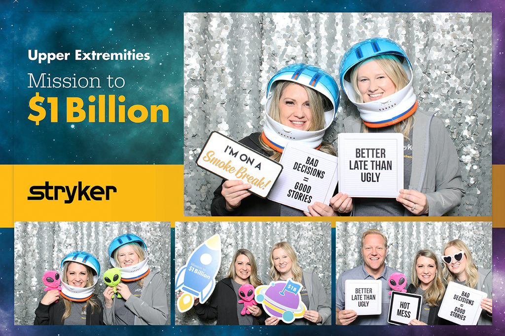 Stryker sales meeting print with coworkers in astronaut helmets and space props for a mission theme