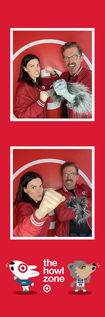 Target Howl Zone branded photo strip with two employees and a wolf mascot paw prop on red