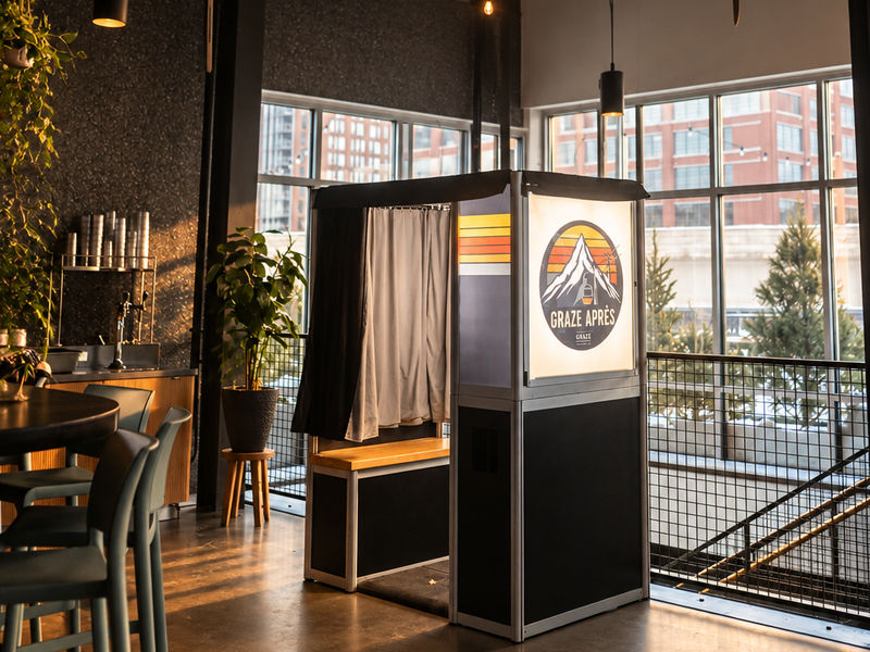 Traditional photo booth set up in a restaurant event space with city views