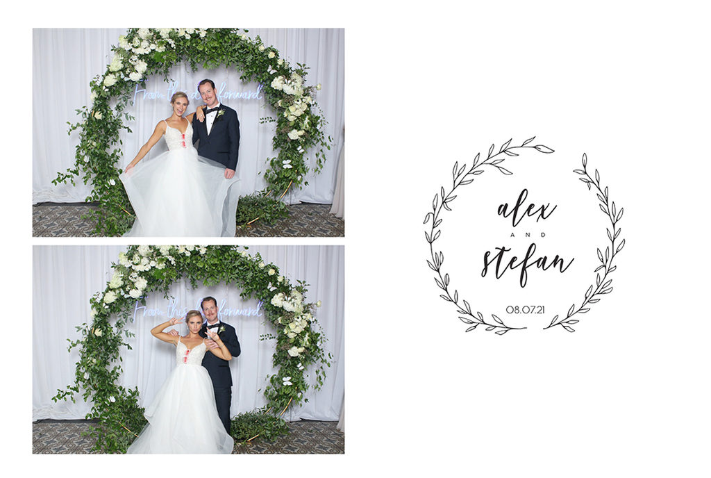 Wedding print of a bride and groom under a greenery arch with a leaf wreath monogram
