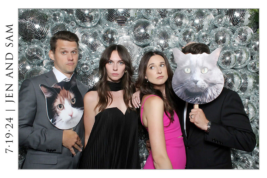 Wedding guests holding giant cat face props in front of a disco ball wall, 4x6 open style print